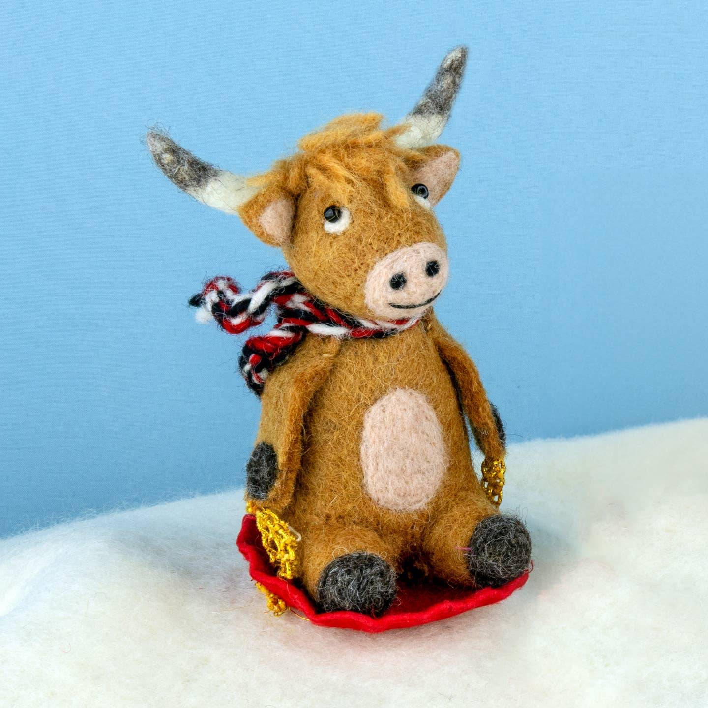 Sledding Highland Cow Ornament